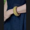 Wooden bangle with brass repousse